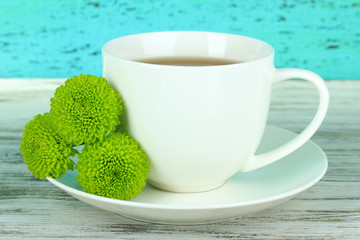 Beautiful green chrysanthemum with cup of tea
