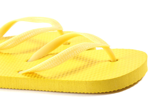 picture of yellow summer flip flops over white