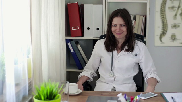 Friendly, happy female doctor in office