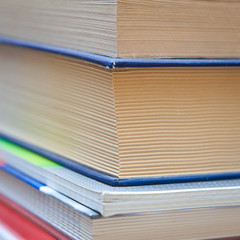 A stack of books and notebooks close up