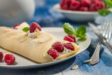 Closeup of raspberry pancakes with mint leaf