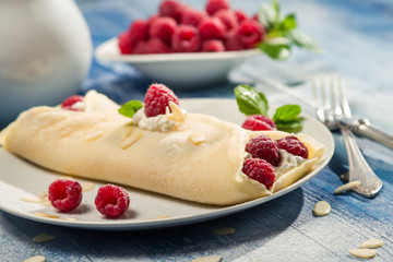 Raspberry pancakes served with whipped cream