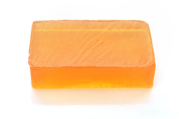 Orange handmade glycerin soap on white.