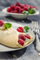 Raspberry pancakes with almonds and icing sugar