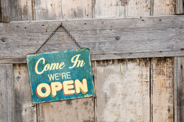 Vintage open sign on old wooden door