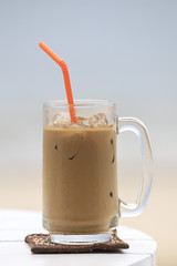 Iced coffee with straw in glass