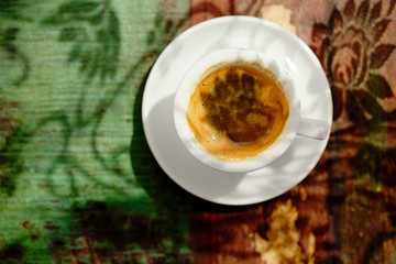 espresso coffee cup on rustic table with sun