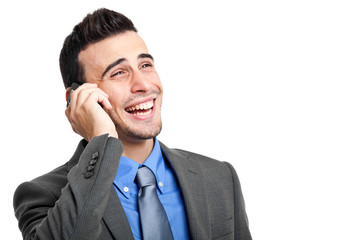 Smiling businessman talking at the phone isolated on white