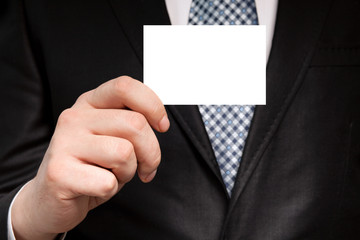 businessman in a suit holding a white business card