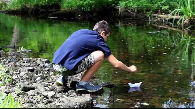 Boy with paper boat near the river episode 1