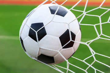 Fototapeta na wymiar football in goal net
