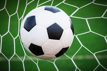 Fototapeta na wymiar soccer ball in goal net