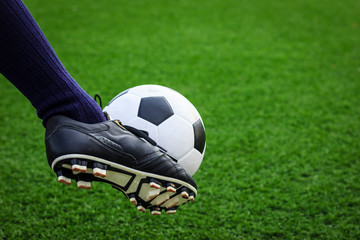 foot kicking soccer ball
