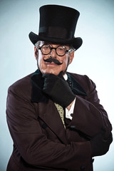Vintage dickens style man with mustache and hat. Wearing glasses