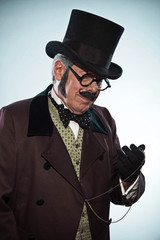Retro dickens style man with mustache and hat. Looking at his an