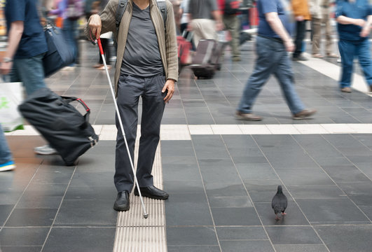 Blind man uses the tactile guidance system in the station