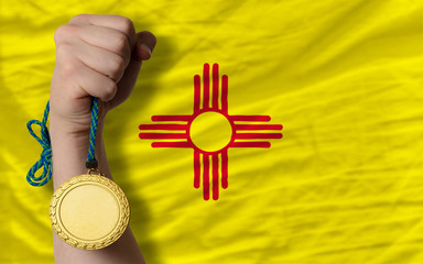 Gold medal for sport and  flag of american state of new mexico
