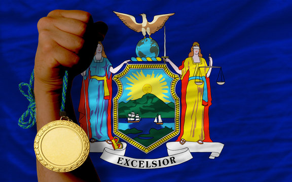 Gold medal for sport and flag of american state of new york