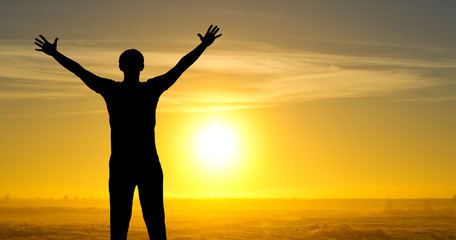 Fototapeta premium Silhouette of man on the field in the morning at sunrice