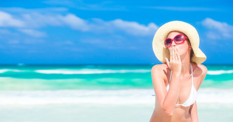 Beautiful woman in white bikini on the beach. Travel concept © el.rudakova