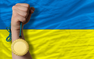 Gold medal for sport and  national flag of ukraine