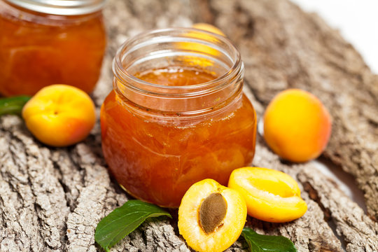 Apricot jam on wooden background