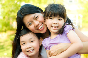 Outdoor portrait of asian mother and daughters