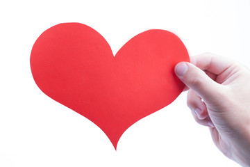 Hand holds heart isolated on a white backgrounds