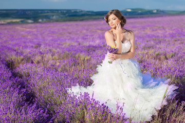 Beautiful bride posing at field of lavender