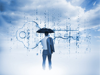 Businessman with an umbrella looking at a giant key
