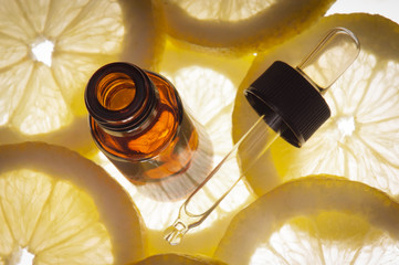 Essential oil amber glass bottle with slices of lemon - 53860248