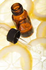 Essential oil amber glass bottle with slices of lemon - 53860647