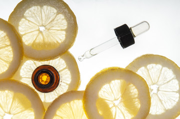 Essential oil amber glass bottle with slices of lemon - 53860816