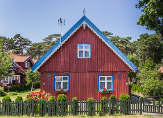 Red house with green fence