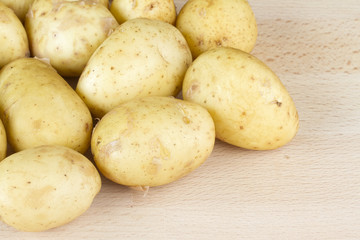 Jersey Royal new potatoes on a wooden chopping board