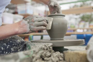 Hands Making Pottery On A Wheel