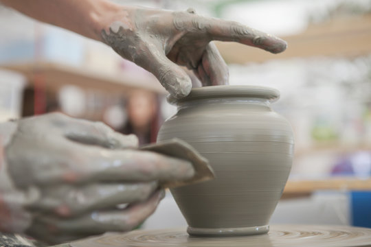 Hands Making Pottery On A Wheel