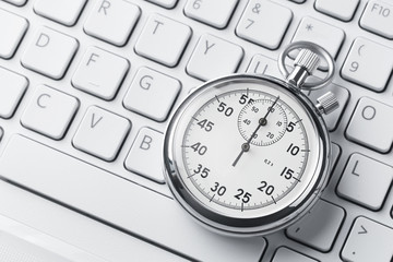 Close up of analog stopwatch on a keyboard