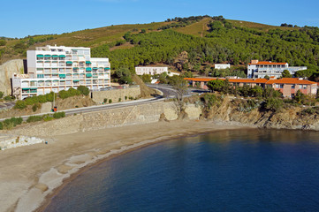 Calm Mediterranean beach with apartment building