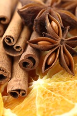 Close-up of dry orange slices, cinnamon sticks, and anise stars.