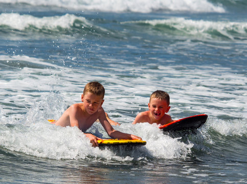 Two boys playing in surf