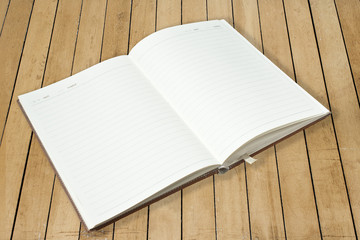 Opened book on wood