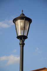 Fototapeta na wymiar Lamp pole and the blue sky, closeup
