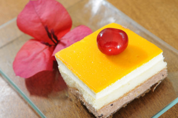 lemon dessert with cherry fruit and flower decorate