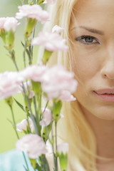 Young blond woman with flowers