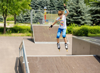 Young girl jumping in the air while roller skating