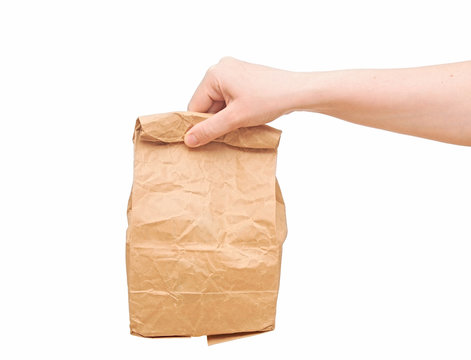 Female Holding A Brown Paper Bag With Contents In His Hand