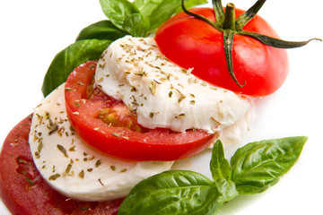 Tomato and mozzarella with basil leaves