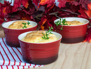 Cheese souffle in red ramekins