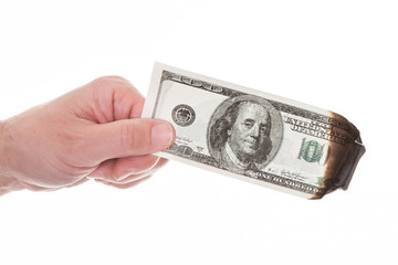 Close-up Of Man's Hand Holding Burnt Currency Note